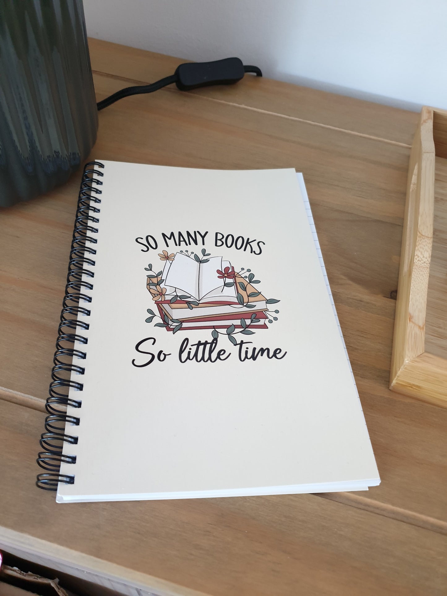 Notebook with spiral binding on a wooden surface.